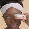 African Amerrican model holding near her face the Combination Skin Cleansing Bar which improves the look of aging skin