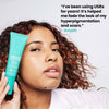 Woman holding bottle of Urban Skin RX Even Tone Barrier Repair Ceramide Cream next to her face