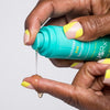 Woman dispensing Urban Skin RX YouthHero AM/PM Serum onto her finger