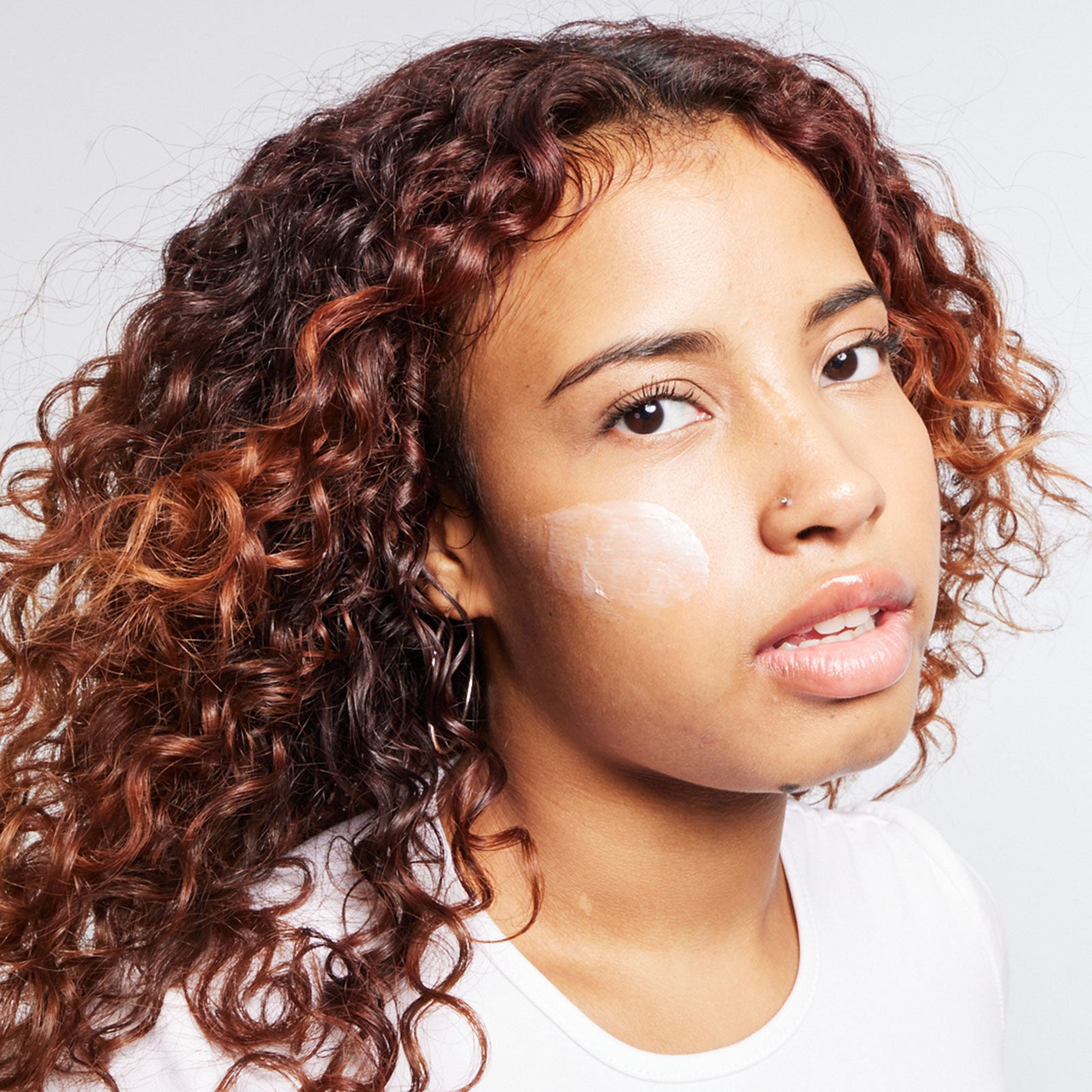 Woman with Urban Skin RX Even Tone Barrier Repair Cream on face