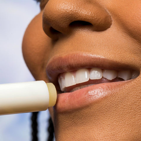 Woman applying Urban Skin RX Cool Mint Sunscreen Lip Balm to her lips