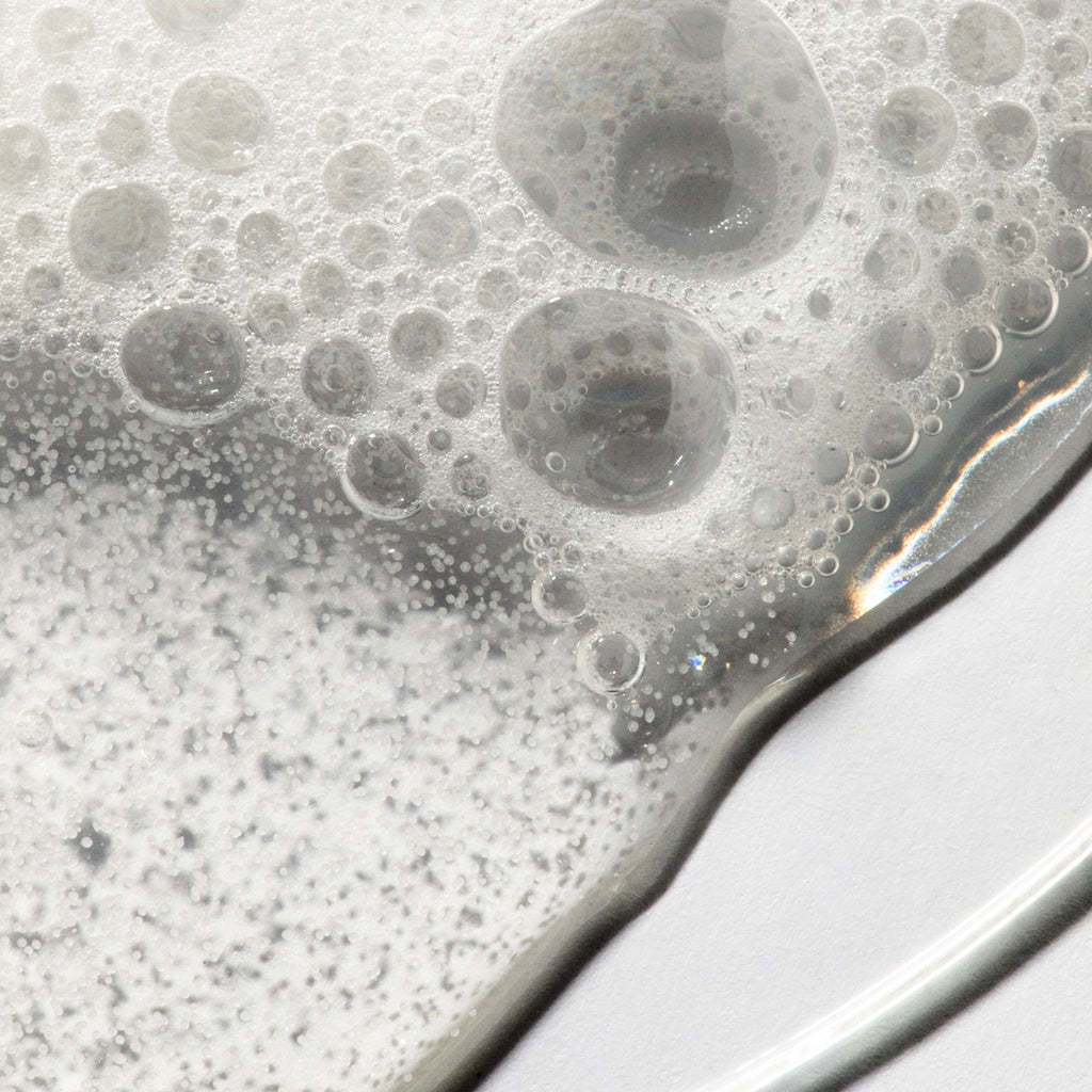 Close up of sudsy bubbles showing texture of Urban Skin Rx LacticGlow Micropolish Cleanser