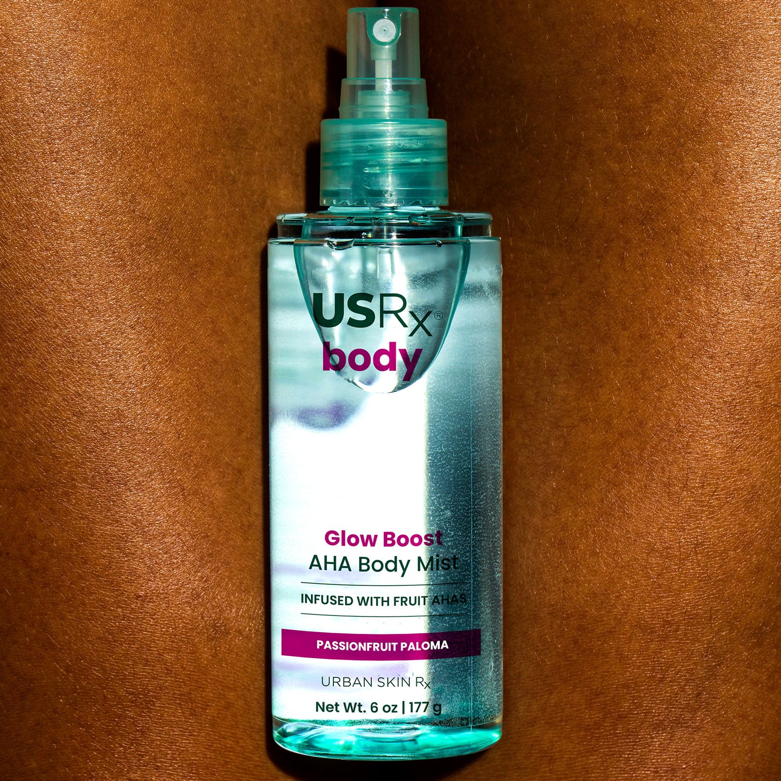 Bottle of USRX Glow Boost AHA Body Mist in Passionfruit Paloma 