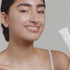 Woman applying USRX Clear Complexion Acne Serum + Spot Treatment to her face