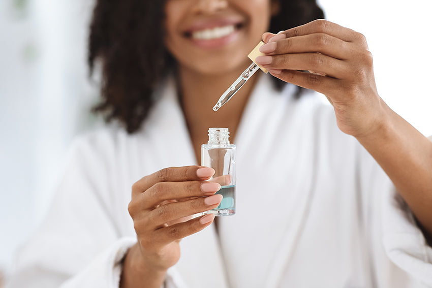 woman using skincare serum