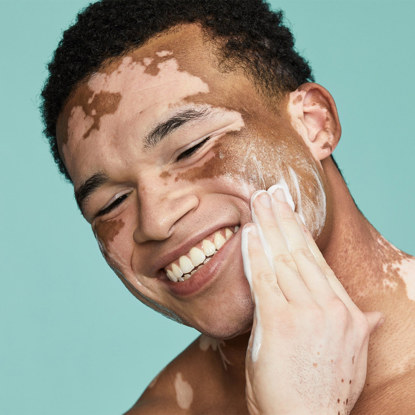 Man washing his face with Urban Skin RX Men's Exfoliating Face Wash + Scrub 