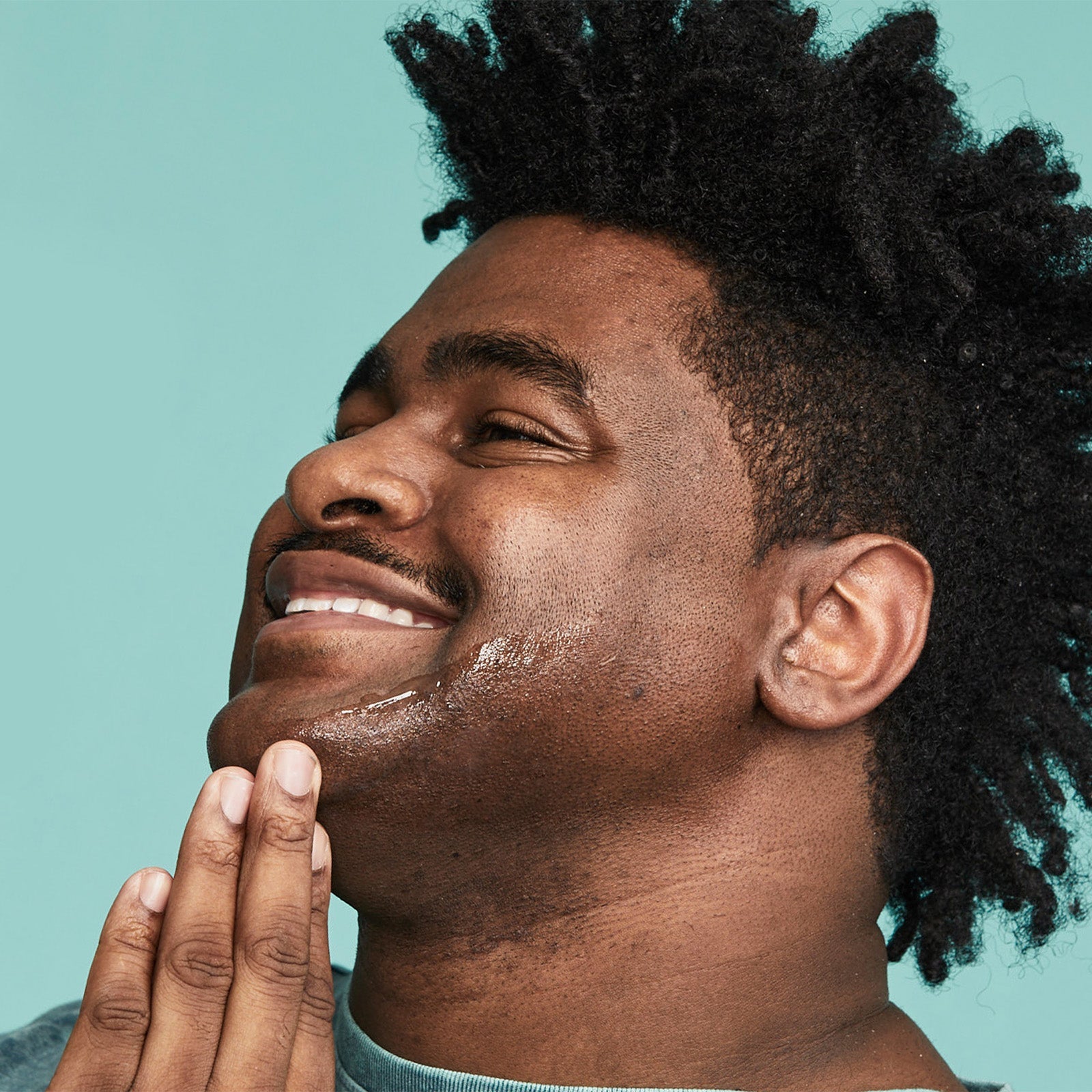 Man applying Urban Skin RX Razor Bump + Dark Spot Treatment to his face