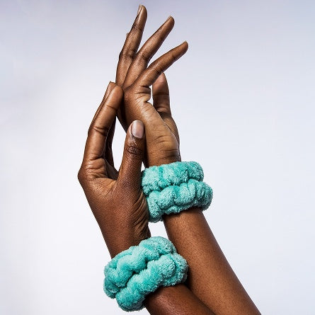 Woman wearing Urban Skin RX water cuffs for catching water while washing face